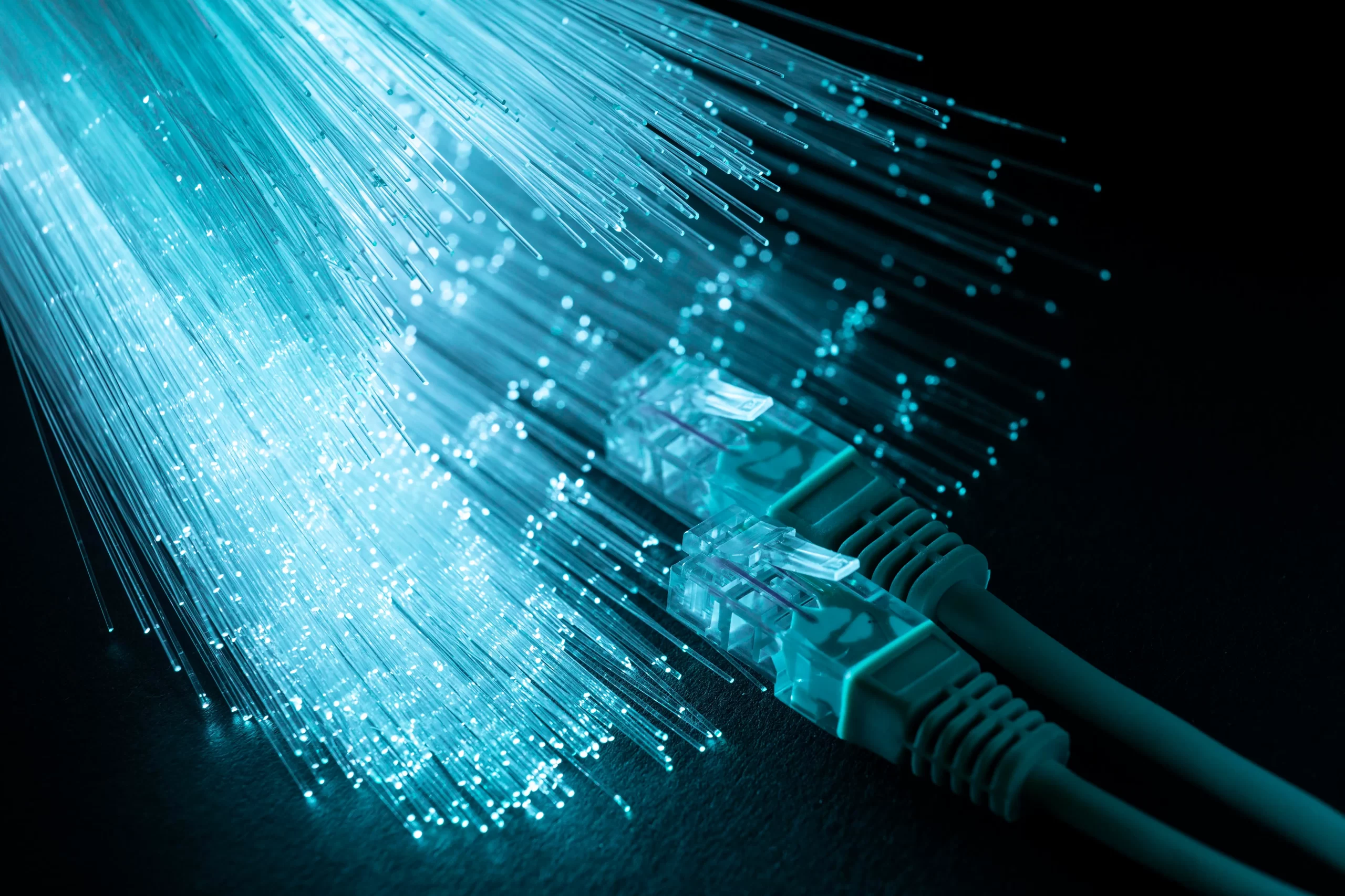 https://www.compu-link.com/wp-content/uploads/2023/06/blue-optic-fiber-with-ethernet-cables-scaled.webp